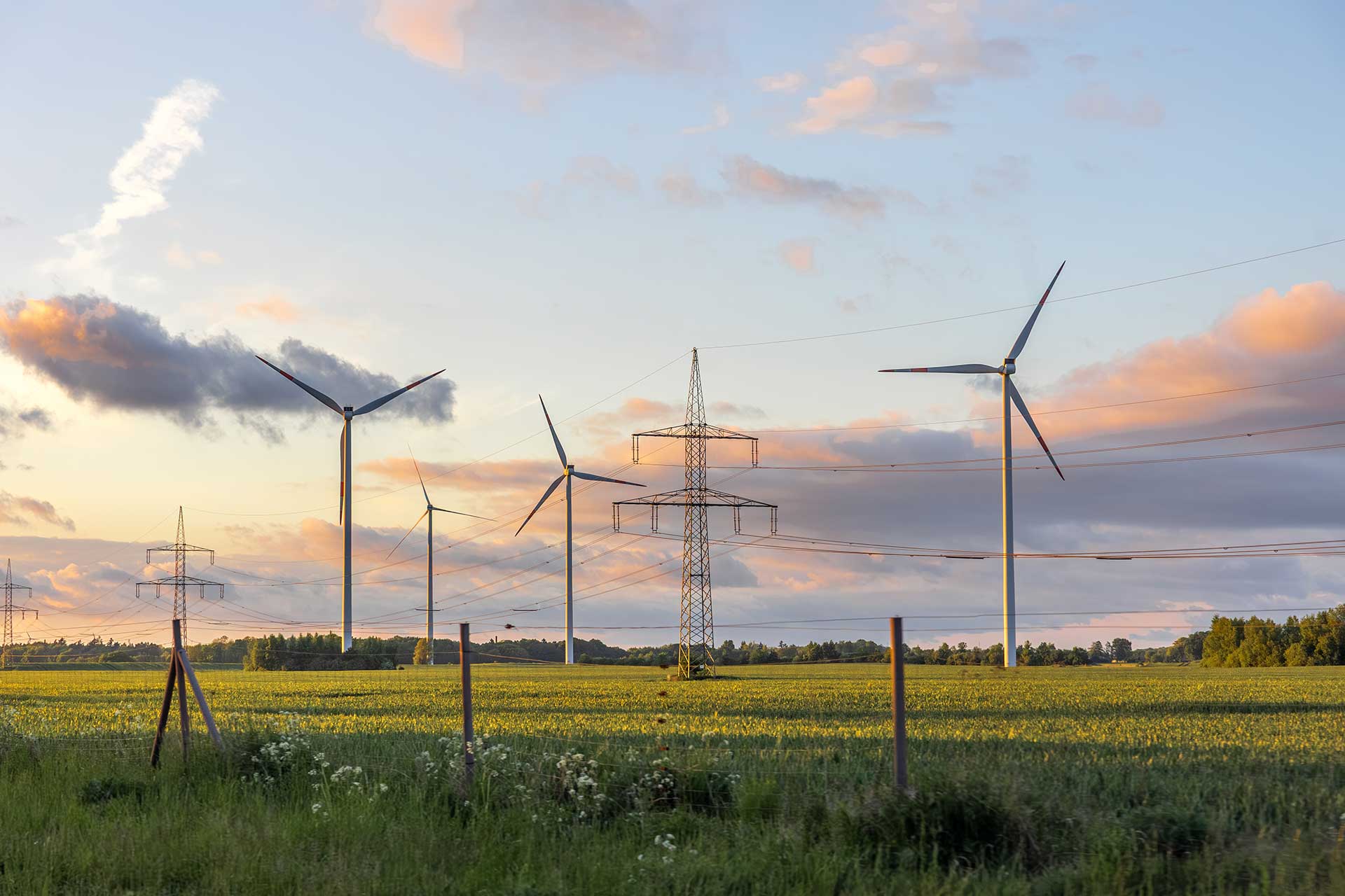 wind-turbines-power-lines-clean-energy-sunset-field-technology